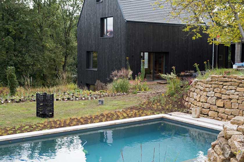 Gepflanzte Stauden im Vordergrund, aufgestellte Stauden zur Pflanzung im Hintergrund.